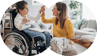 A child using a wheelchair connecting with a supportive adult at home