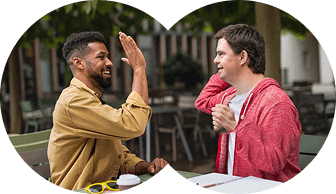 Two people communicating with sign language at a table